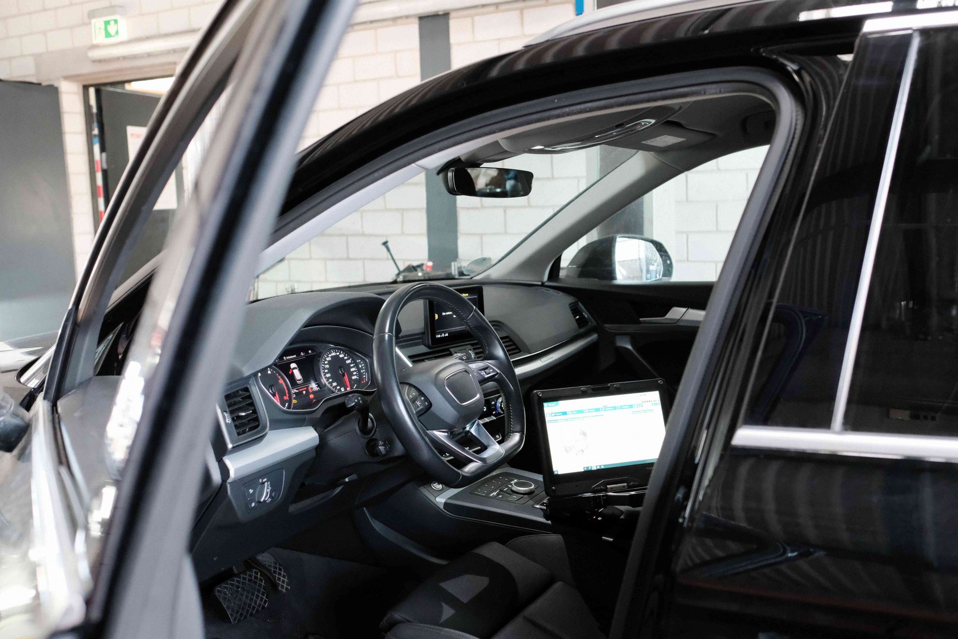 Vehicle interior with engineering displays and controls during automotive testing and validation work.
